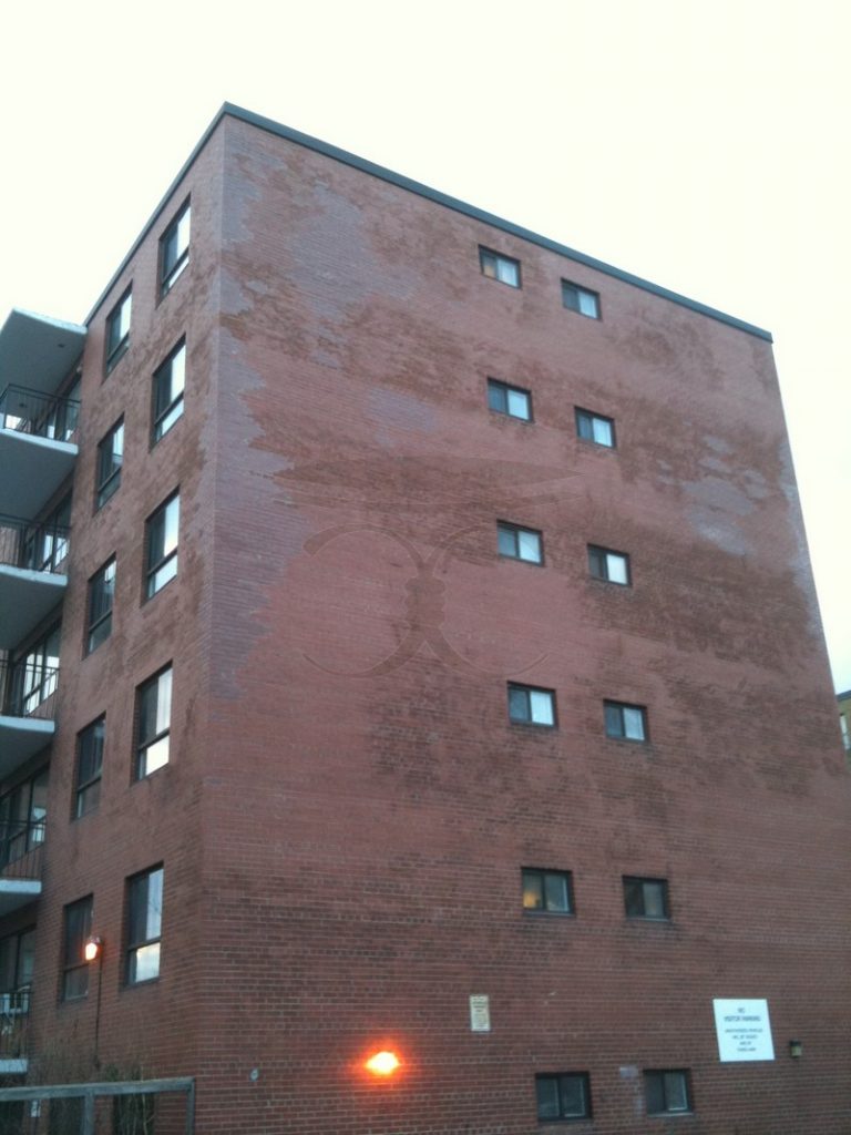 Six-storey brick apartment building after Cummins Restorations rebuilt its damaged brick corner