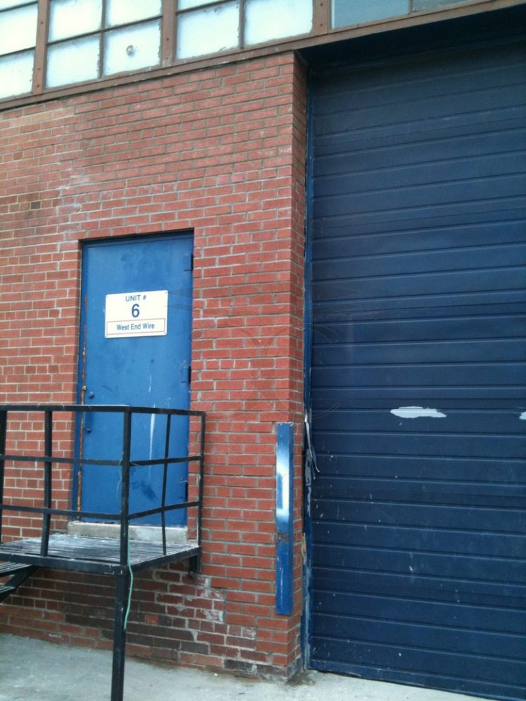 Brick wall beside the loading-dock door rebuilt