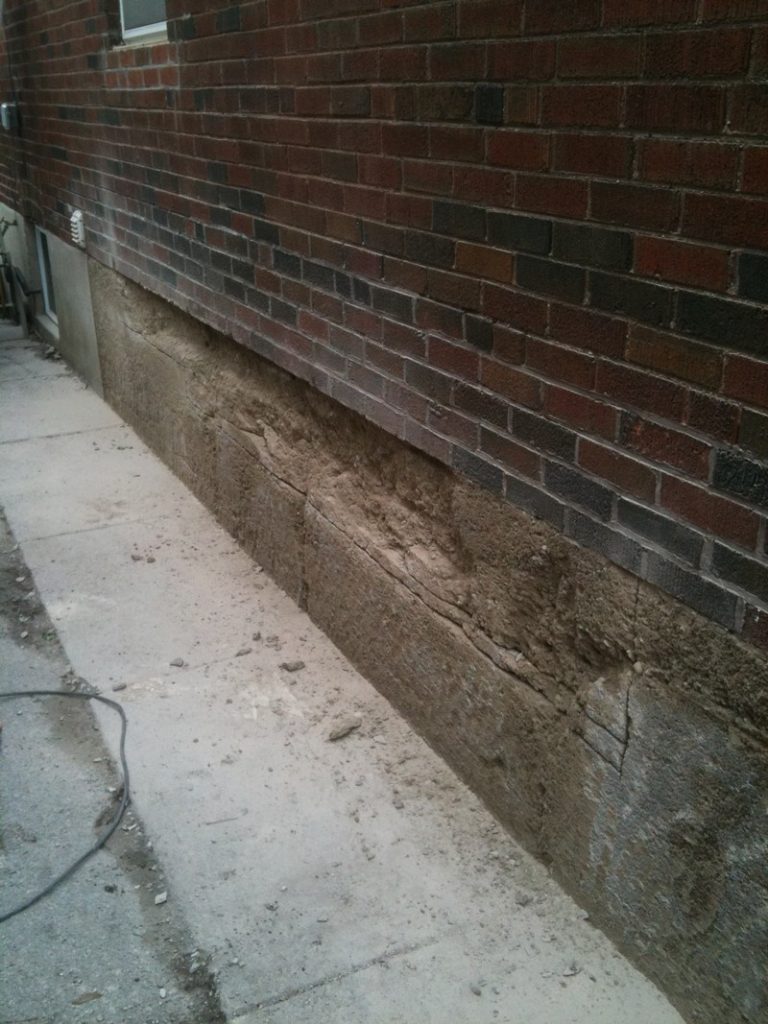 Foundation wall prepared with the old coating removed