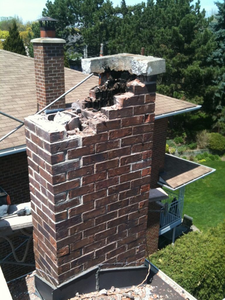 Brick chimney with a broken, partly collapsed top