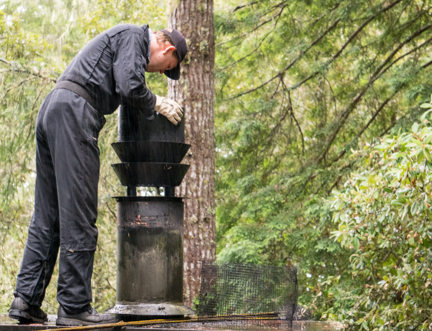 repairman checking chimney odors