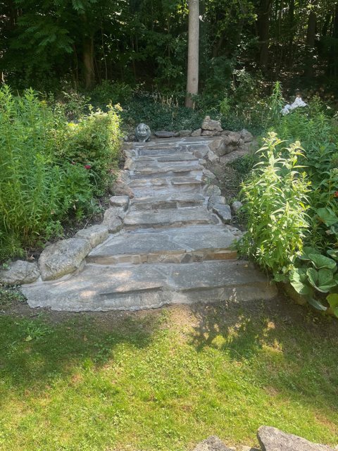 Natural flagstone steps leading through a planted garden